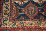 Antique Kurdish rug detail: primitive arabesque border, rich blues, reds, and foundation visible.