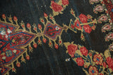 Even wear across antique Senneh rug's charcoal pile with madder red motifs and holes.