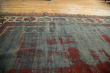 Dynamic textural field of antique Kazak runner featuring blue and cherry red motifs.