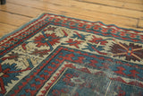 Antique Caucasian Kazak runner corner, geometric Laleh Abassi motifs in teal, red, ivory, and varied pile.