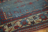 Close-up of an antique Kazak border: sharp red and teal serrated contours, Laleh Abassi motifs.