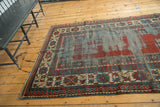 Textured antique Caucasian Kazak runner, geometric Laleh Abassi border, and worn field.