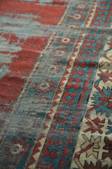 Textural detail of antique Kazak rug with serrated Laleh Abassi motifs, rich cherry, teal, and beige tones.
