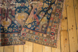 Geometric patterns and unique Soumac texture of a Caucasian rug in navy, gold, and red.