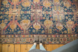 Hand-woven geometric border of the antique Soumac rug in indigo, red, and gold.
