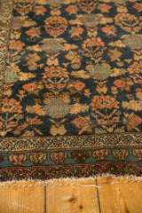 Antique Persian Malayer rug border with navy, raspberry blossomed flowers and worn fringe.