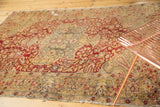 Antique Turkish Kaisary rug featuring an oversize medallion and floral field with wine red, gold, and silver tones.