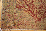 Tattered fringe and worn floral field of an Antique Turkish Kaisary rug corner.