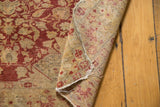 Hand-knotted foundation and worn edge of the Antique Kaisary rug, displaying a red floral reverse.