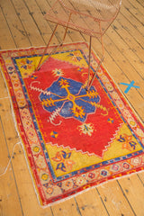 Sharp lightning serrated contour of the blue medallion on the red field of a vintage Oushak rug.