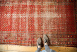 Antique Malayer runner, displaying extensive wear, exposed foundation, and red Mir boteh design.