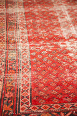 Hand-knotted bright red field with Mir boteh pattern and starburst border, showing foundation wear.
