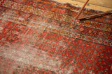 Antique Malayer runner's red Mir boteh field, starburst border, revealing aged texture and ivory foundation.