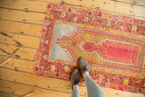 Starburst motifs in light blue and madder red on an antique Mudjur rug corner.
