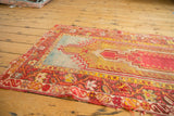 Antique Mudjur rug, featuring red prayer design, saffron yellow field, and intricate floral borders.
