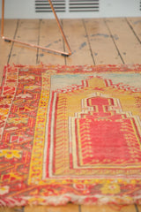 Antique Turkish Mudjur rug's madder red prayer field, saffron yellow border, starburst motifs, and aged fringe.