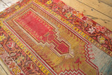 Antique Mudjur rug corner: red prayer, gold teared outlines, and faded blue patina.