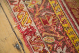 Antique Mudjur rug's aged edge, showcasing red, saffron yellow, and ivory motifs.