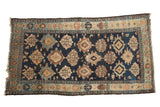 Antique Malayer rug, indigo blue field, geometric medallions, dusty gold and sky blue motifs.