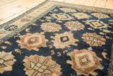 Antique Malayer rug's indigo field with geometric medallions, marine life, and knot wear.