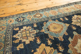 Antique Malayer runner: deep indigo and gold geometric patterns, aged pile, tattered edge.