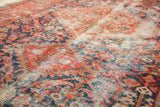 Antique Malayer rug detail: worn red, indigo henna design, foundation visible through pile.