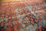 Traditional Persian Malayer rug: worn field with Herati-style henna plant motif, indigo, blush.