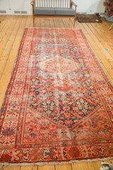 Antique Malayer runner corner with henna plant pattern, indigo, blush red, and aged pile.