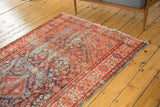 Antique Malayer runner, worn indigo and red field with intricate henna plant motif and tattered edges.