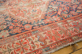 Antique Malayer rug's intricate henna border in red and indigo, with visible pile wear.