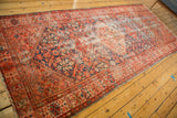 Antique Malayer runner border and field detail with henna motif, tattered fringe, time-softened tones.