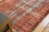 Antique Malayer rug runner's red and blue border with tattered edges, worn henna plant motif.