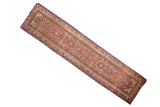Antique Karabagh runner with intricate multi-colored Herati pattern on a charcoal brown-black ground.