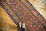 Antique Karabagh runner detail, showcasing its vibrant Herati design, colorful borders, and worn end.