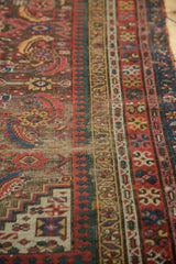 Close-up of antique Karabagh runner's vibrant, multi-layered borders and worn patterned pile.