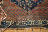 Antique Afshar rug border detail with stylized motifs, worn pile, and tattered foundation.