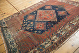 Antique Afshar rug end with rich geometric border, intricate motifs, and characteristic tattered fringe.