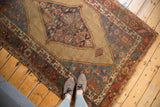 Antique Bijar rug with vibrant tribal border motifs and serrated medallion edge.