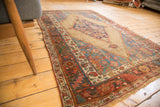 Close-up of antique Persian Bijar rug's serrated tribal patterns, camel field, and secured fringe.