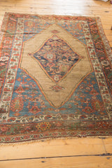 Antique Bijar rug's mostly secured end, worn fringe, and tribal madder red border.