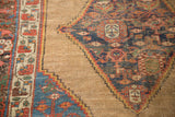 Serrated navy tribal medallion, madder red border on natural camel field of antique Bijar.