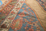 Antique Bijar rug with sharp serrated tribal patterns in blue, madder red, and camel.