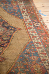 Natural camel field, serrated diamond medallion, and tribal borders of an antique Bijar rug.