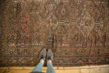 Antique Kamseh rug: worn pile, exposed foundation, and tattered fringe.