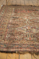 Muted antique Persian Kamseh rug with intricate geometric motifs, even wear, and tattered fringe.
