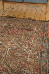 Visible tatter on the dark fringe and tribal border of this antique Kamseh rug.