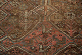 Textured pile of an antique Kamseh rug, with dusty blush and slate blue geometric motifs.