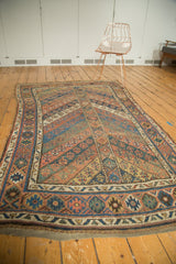 Antique Kurdish carpet with geometric parallel design motif, displaying aged blue and copper colors.
