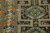 Detail of antique Caucasian rug with geometric medallion, comb animals, and areas of historic wear.