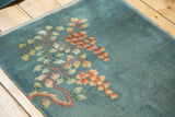Vintage Nichols Art Deco rug: asymmetric floral bouquet in tangerine orange, blush, and celadon green.